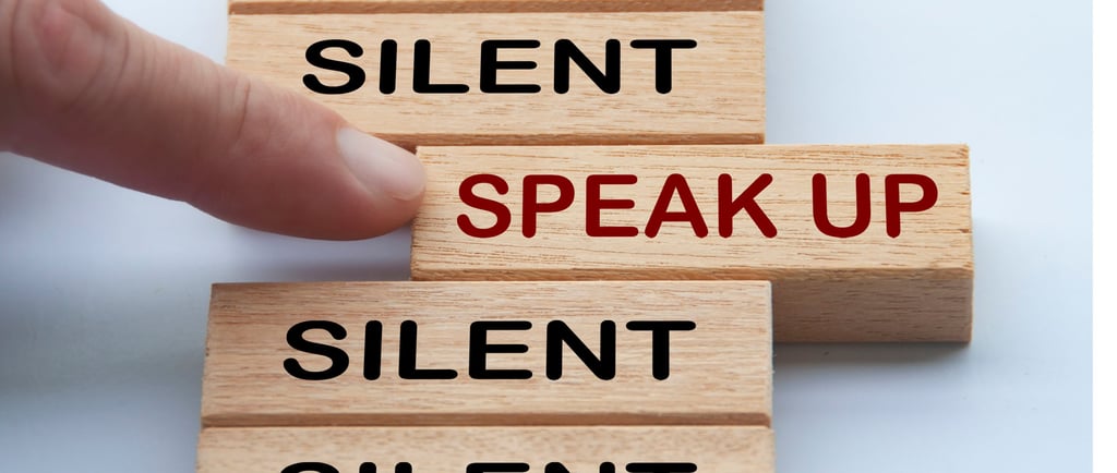 this is a photo pf a women touching what looks like a gamw piece that says "speak up" on it. 