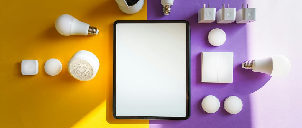 A flat‑lay arrangement of smart home devices placed around a tablet with a blank screen, displayed on a split yellow