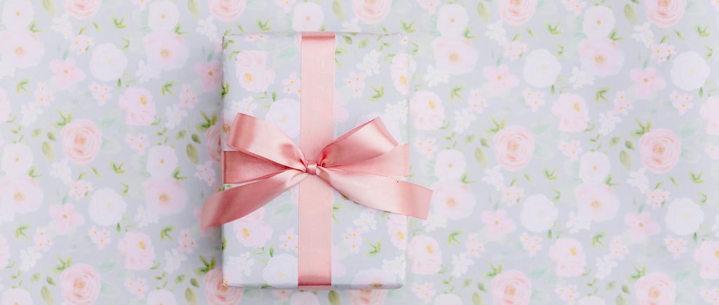 a gift wrapped in pink ribbon and tied with a pink ribbon