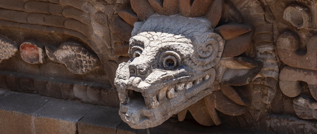 Ancient stone carving of Quetzalcoatl, the feathered serpent deity at Teotihuacan temple in Mexico.