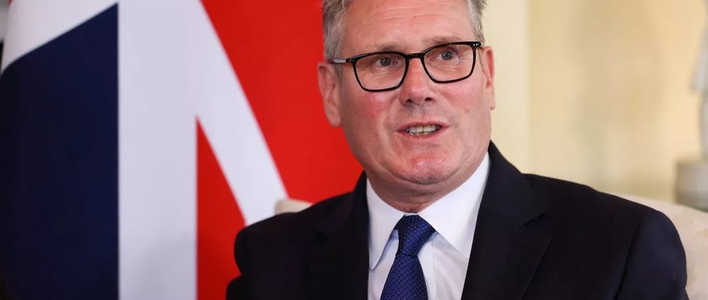 a man in a suit and tie with a british flag