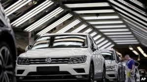 a volkswagen logo on a car in a factory