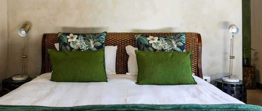 Bed centered against plaster wall