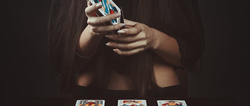 woman holding tarot cards during a tarot reading