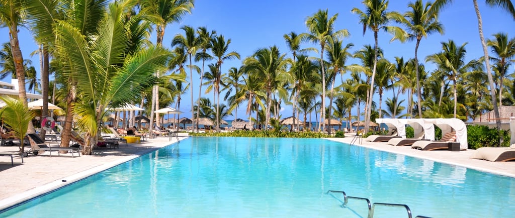 a pool with a swimming pool and lounge chairs