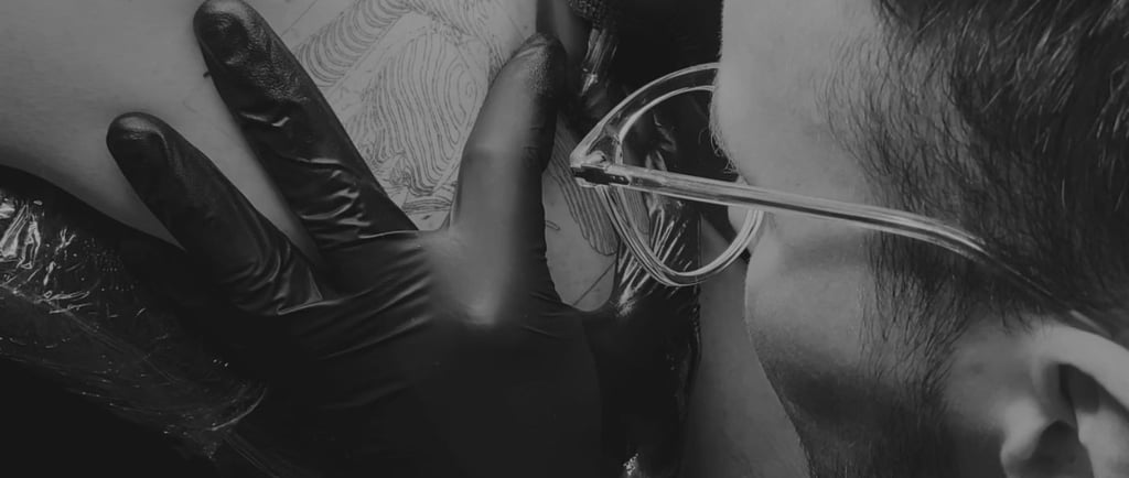 a man in a black and white photo of a tattoo artist