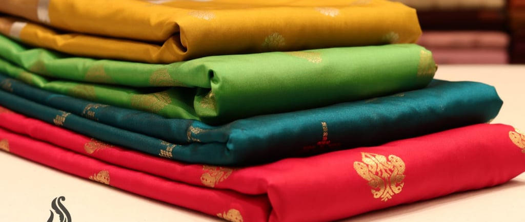 a stack of folded folded folded fabric with a gold leaf design