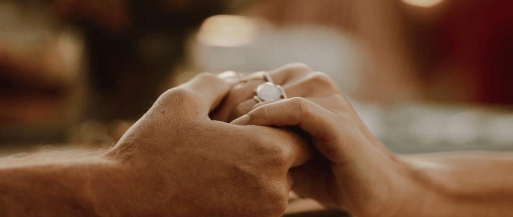 Couple holding hands for emotional support after miscarriage