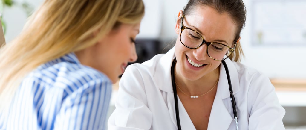 Female doctor warmly explaining fertility results to a patient