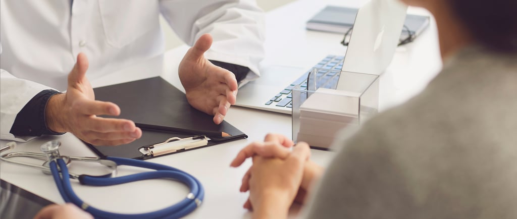 Fertility doctor explaining IVF process to patient during a clinic visit