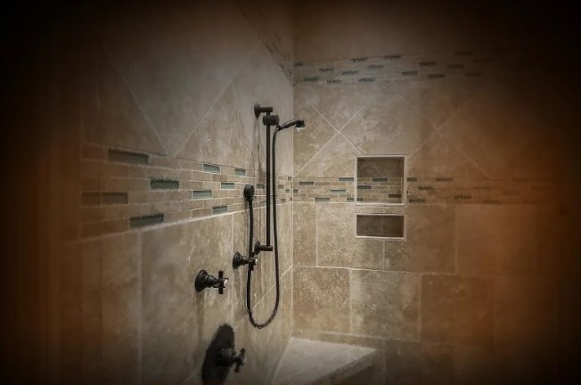 Modern tiled shower showing waterproofing work, emphasizing the need for expert evaluation in water damage insurance disputes