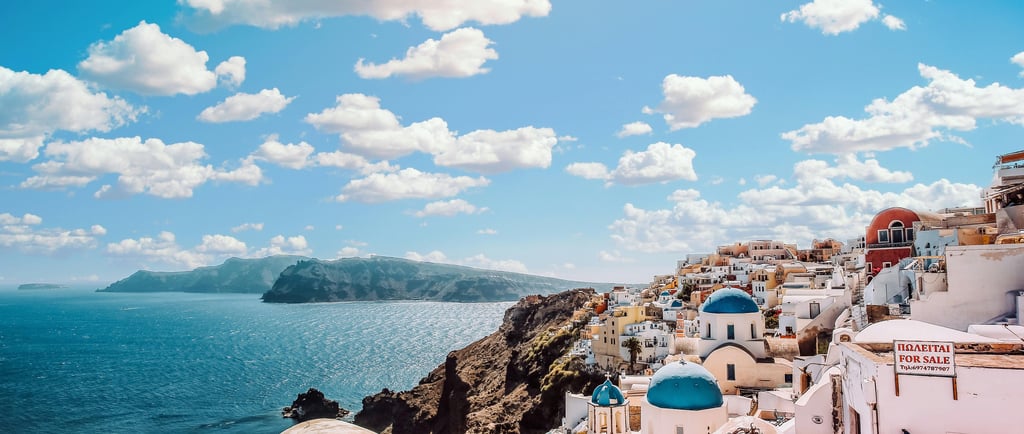 Beautiful view of Santorini with blue domes and calm September skies