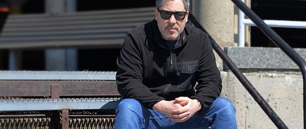 a man sitting on a bench in a stadium