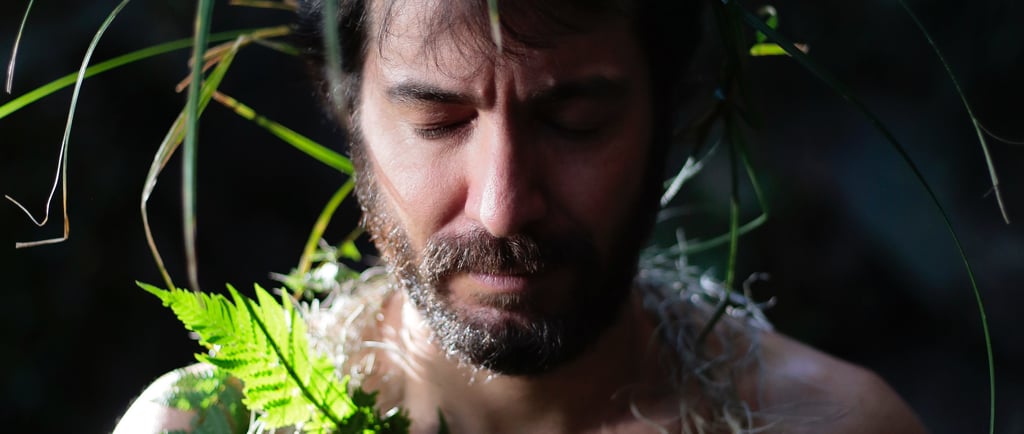 a man with a beard and a beard, wearing a hawaiian style lei lei lei