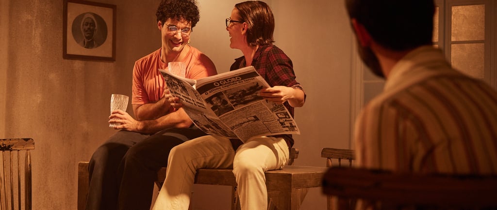 a man and woman sitting on a bench in a room