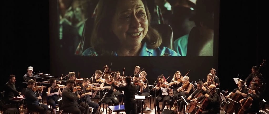 a conductor and orchestra in a concert