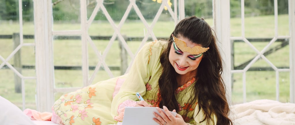 a woman in a green dress is laying on a bed