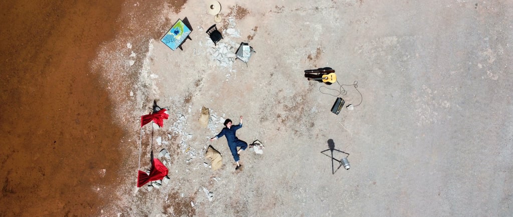 a person laying on a beach with a surfboard