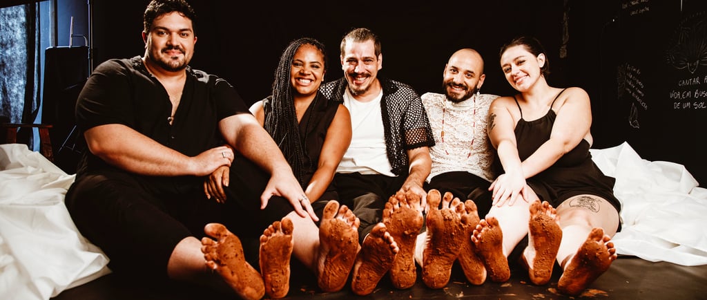 a group of people sitting on a bed