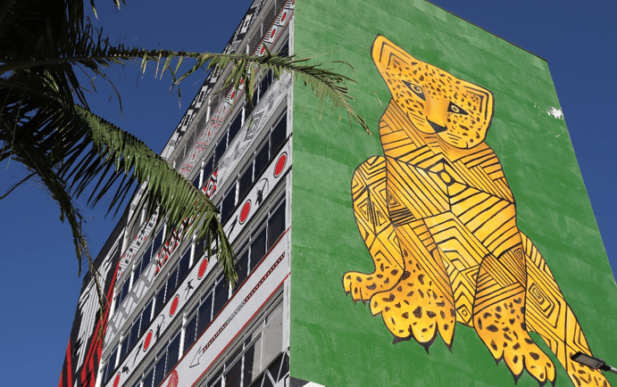 a large green and yellow mural of a leopard