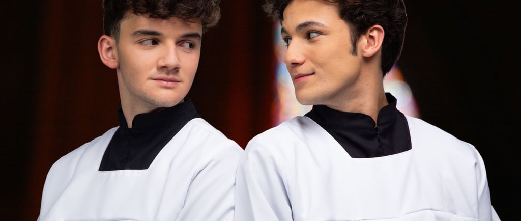 two men in white robes standing next to each other