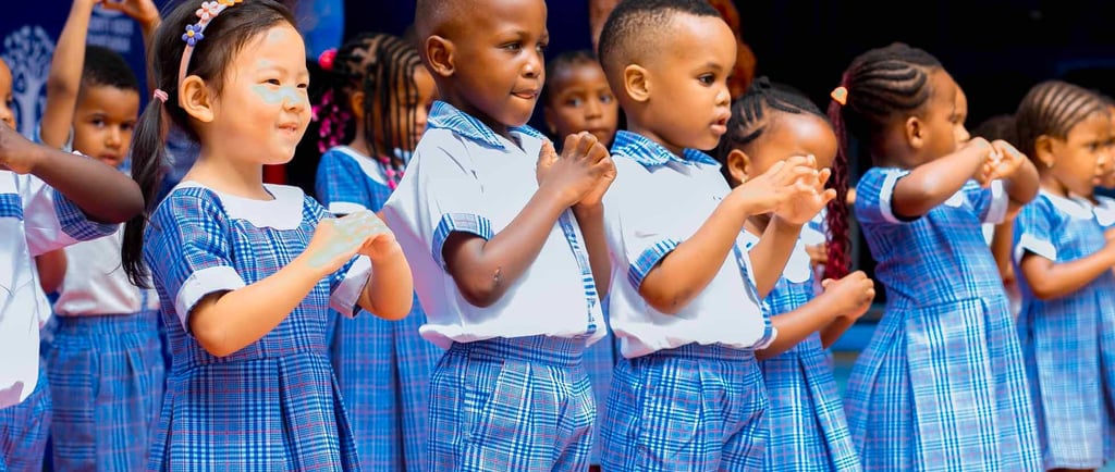 A group of confident students presenting on stage at a school assembly, with parents in attendance.