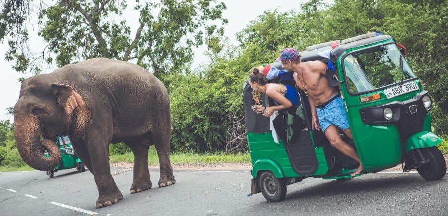 a man riding a tuk tuk tuk tuk tuk with a