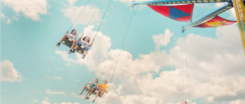 a group of people riding on a swing line