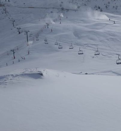 a person skiing down a snowy mountain slope
