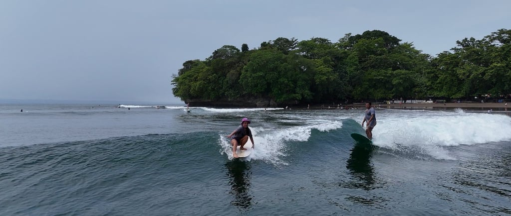 Surf lessons longboarding in Batukaras with Ucup of USurf Batukaras