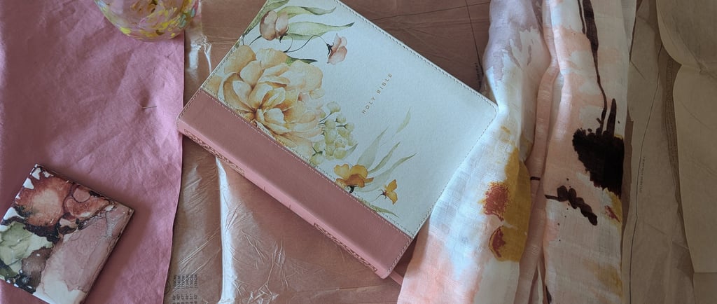 An image of the Holy Bible around fabric and sewing pattern. Connecting faith and creativity.