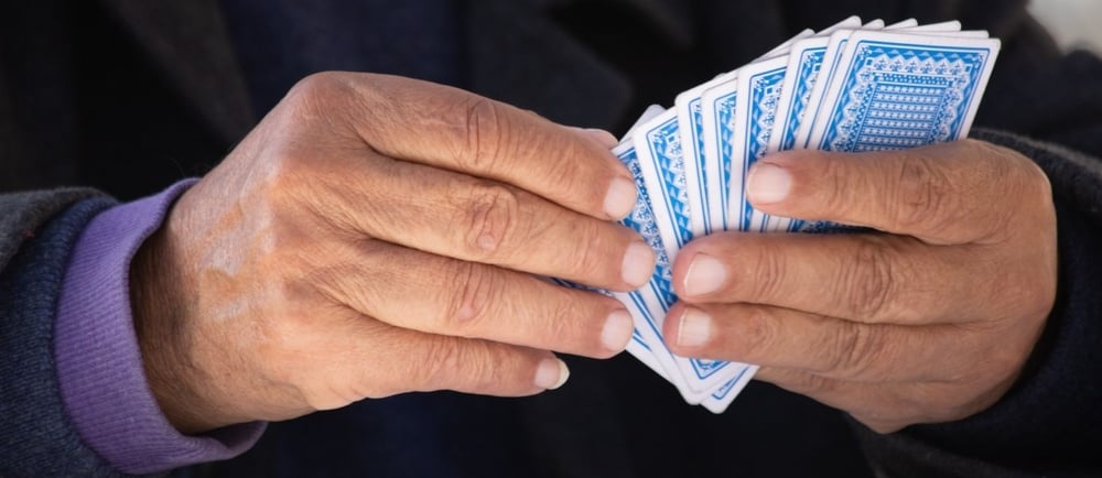 Person holding playing cards