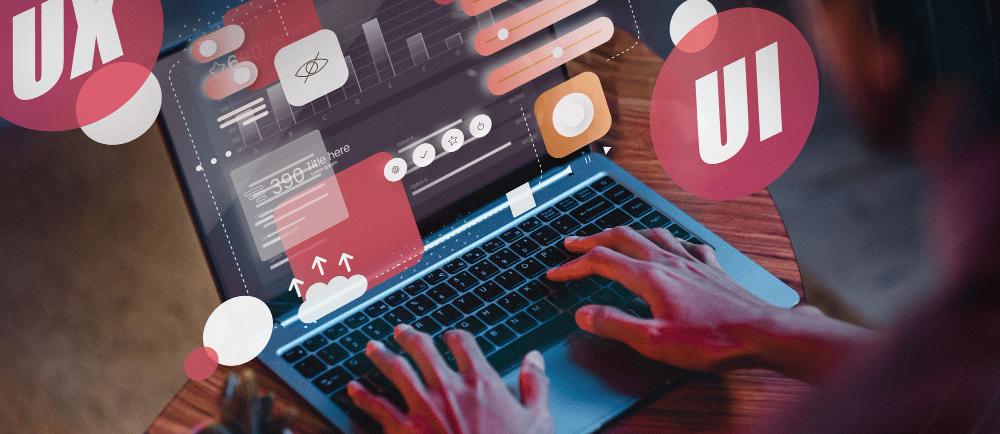 Designer projetando uma landing page na tela de um notebook com os símbolos UX e UI