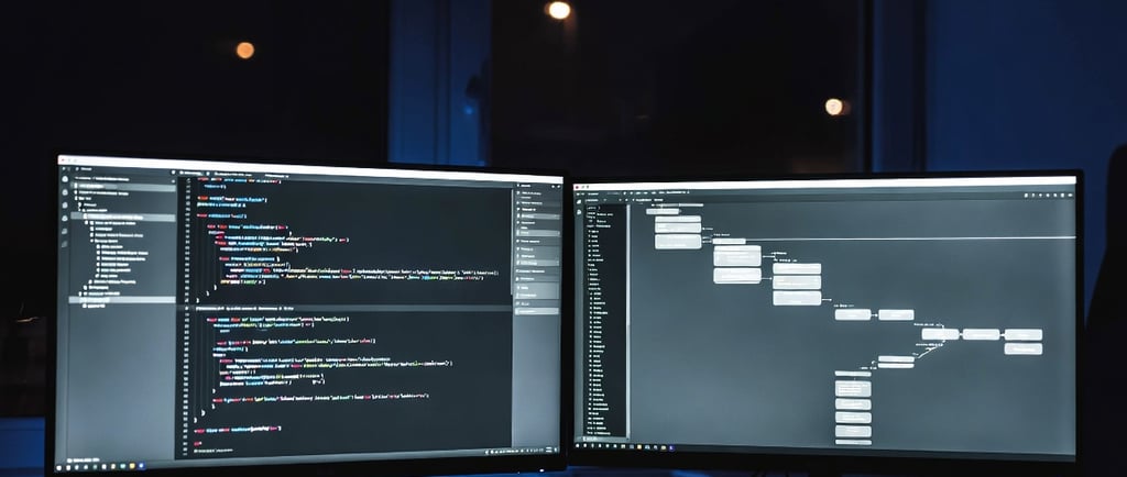 Dual monitor setup for software development showing lines of code and a flow chart.