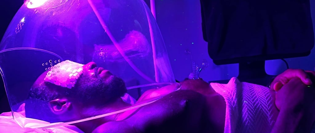 a man at the spa enjoying purple light oxygen dome treatment