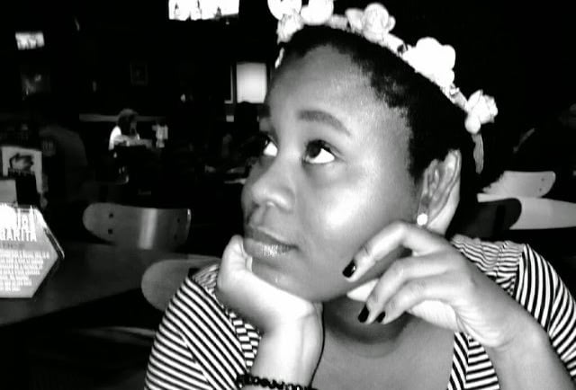 a woman in a striped shirt and a crown crown