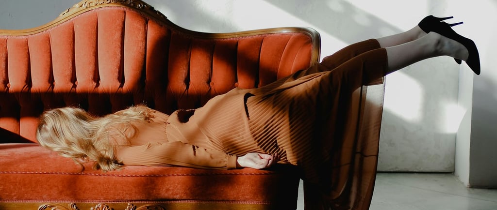 woman face down on orange couch