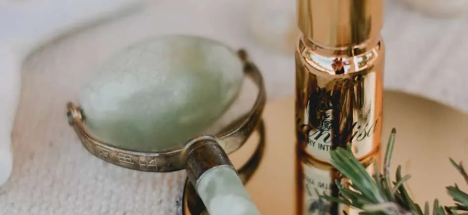 a bottle of liquid in a gold toned and a bottle of liquid