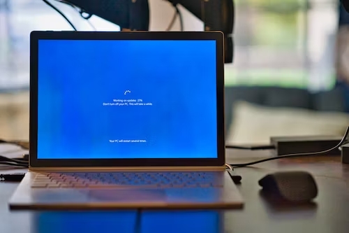 a laptop computer with a blue screen and a mouse