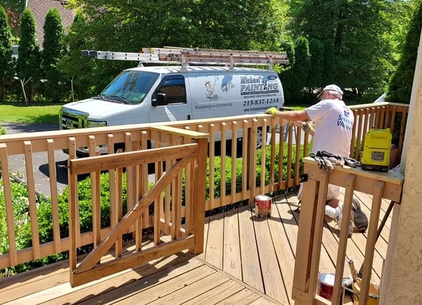 a man painting a deck deck