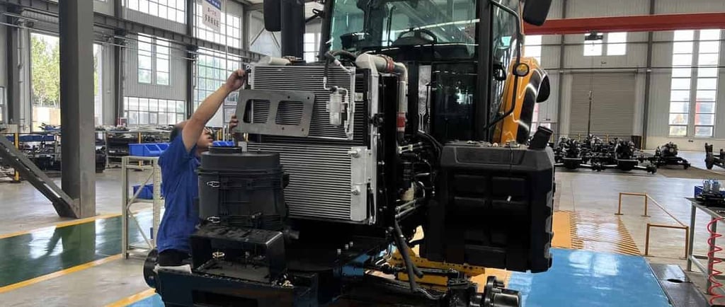 a man standing in a factory with a machine