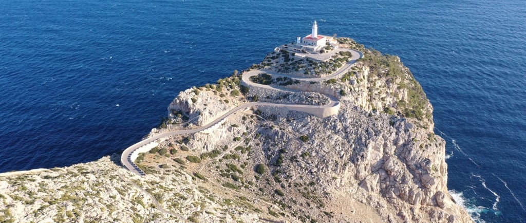 Aerial view of Cap de Formentor lighthouse in Mallorca with dramatic cliffs overlooking the Mediterr
