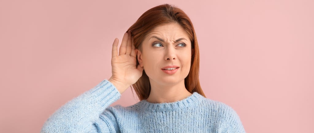 woman with blue jumper with hearing problems