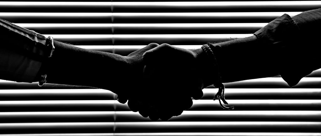 two friends holding hands in trust