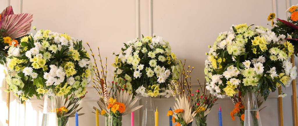 a row of vases with flowers in them