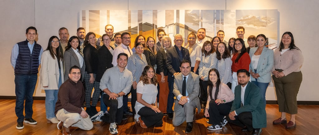 Francisco poses proudly with Hispanic Austin Leadership classmates, gathered for a group photo.