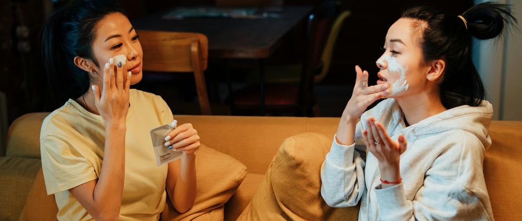 two woman applying face cream