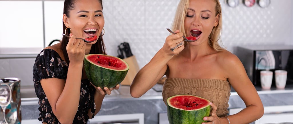 Two women eating watermelon
