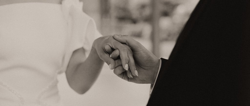 a bride and groom holding hands in a wedding ceremony