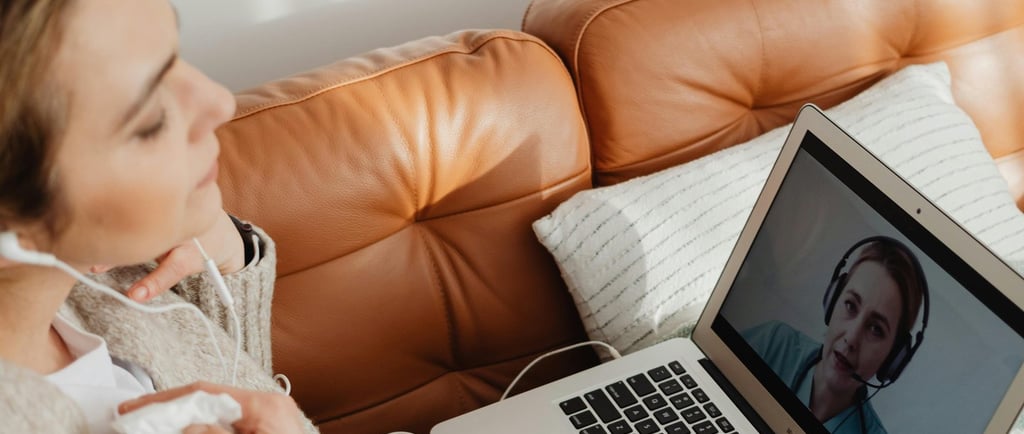 A hypnotherapist and a client doing an online hypnotherapy session via video call